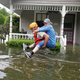 A Texas National Guard soldier carries a woman on his back as they conduct rescue operations in flooded areas around Houston, on Aug. 27.